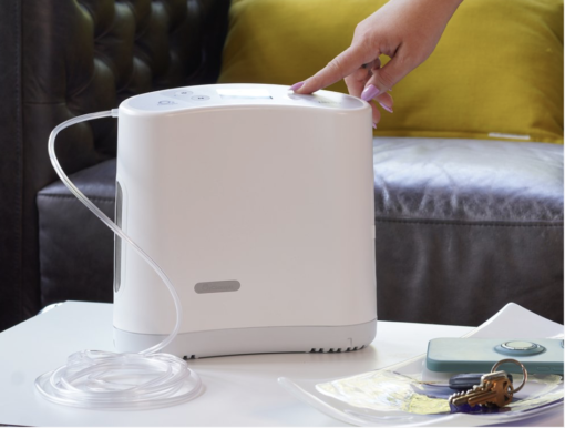 A Oxlife LIBERTY™ Portable Oxygen Concentrator on a coffee table.