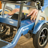 A person inserting the Journey So Lite® Foldable Power Scooter Rechargable battery into position