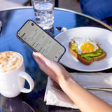 checking the stelo app while eating breakfast