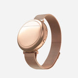 A rose gold Embr Wave 2 device with matching wristband