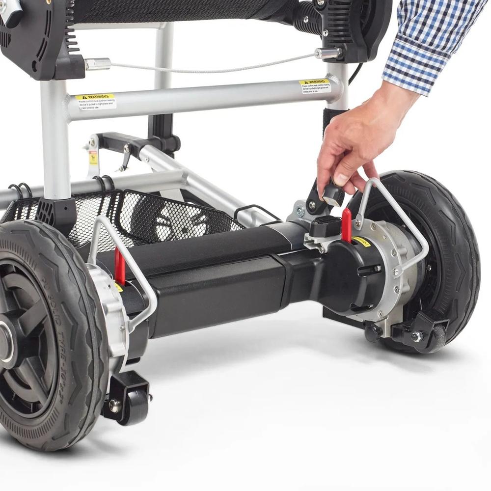 A person inserting the power cord into the Journey Zoomer® Folding Power Chair wheel motor unit.